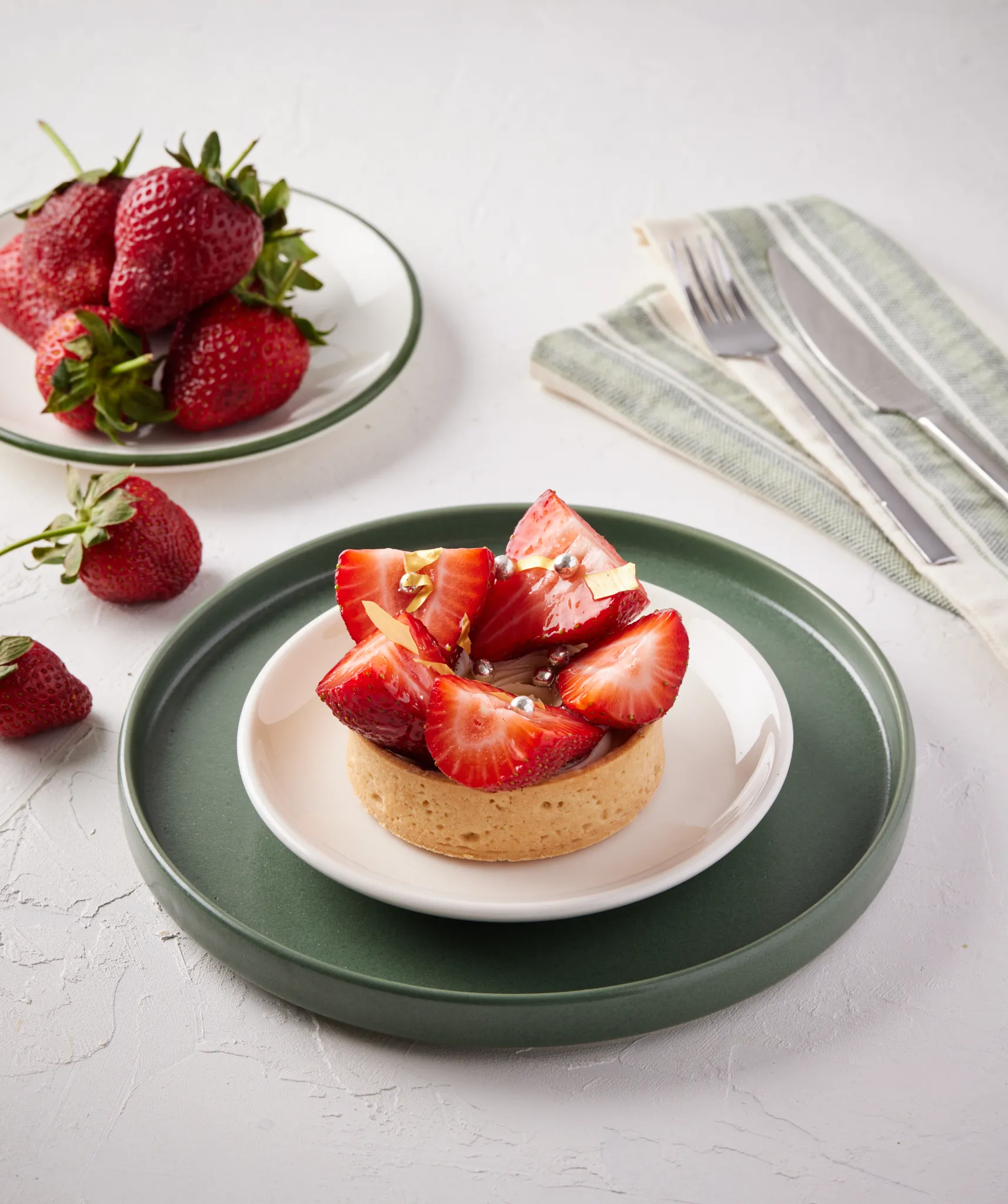 Atlanta food stylist — strawberry tart on stacked plates with linens