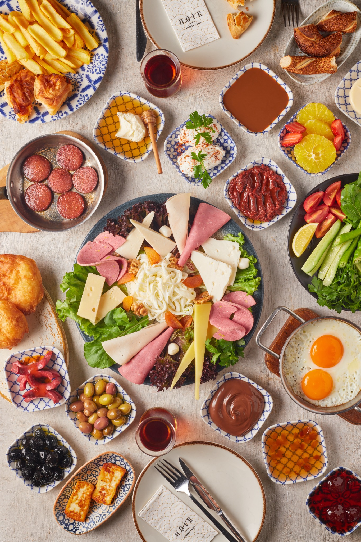 Turkish breakfast spread with tea and assorted small bowls – hospitality photography in Atlanta.
