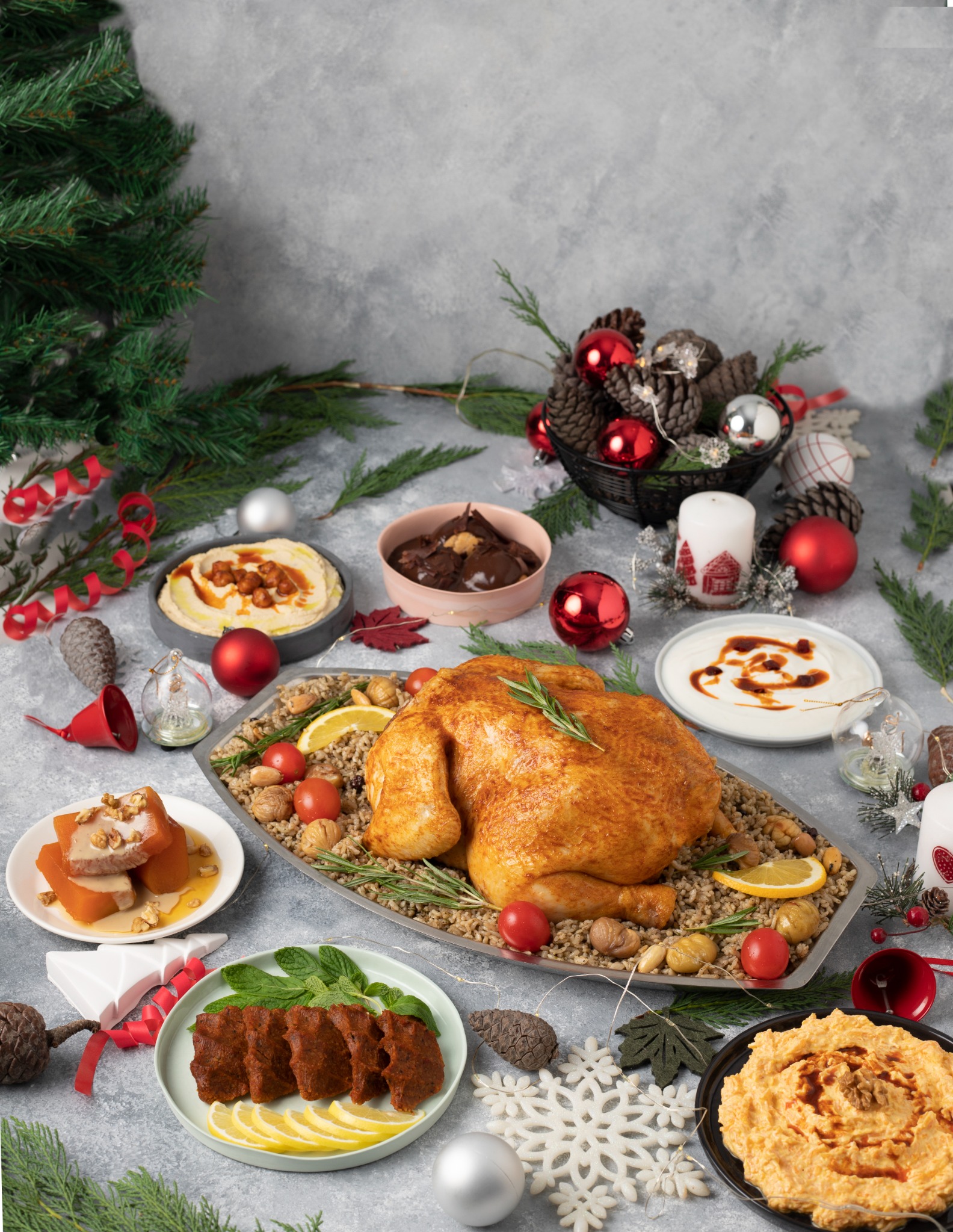Roasted turkey platter with holiday decor and meze plates – three-quarter angle.