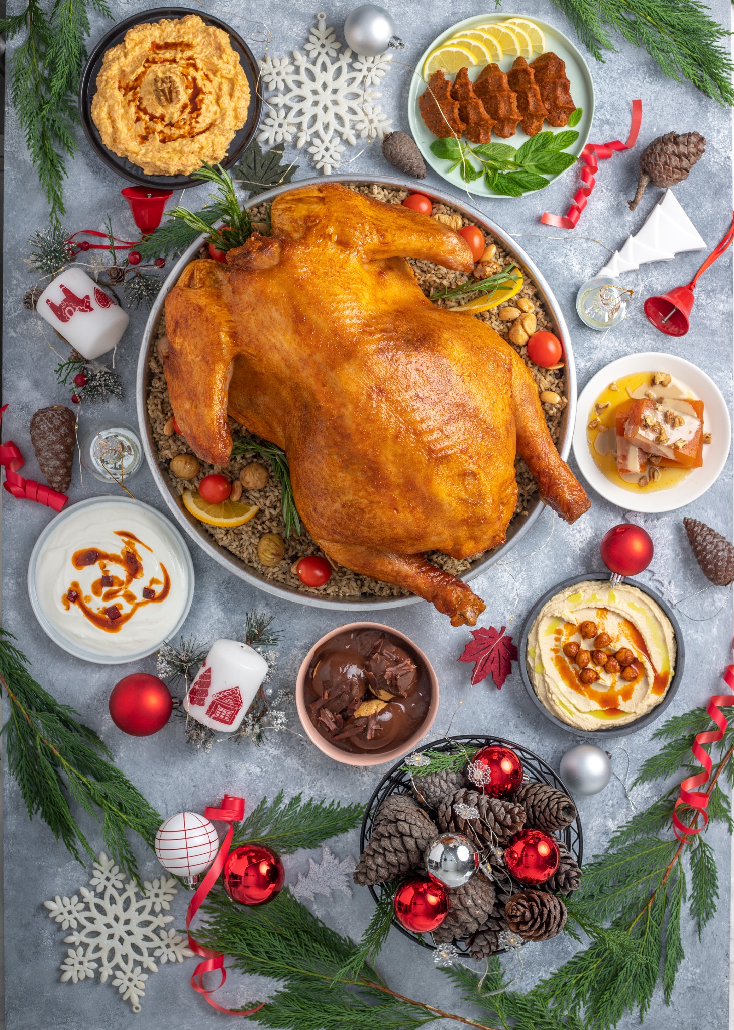 Roasted turkey on pilaf surrounded by holiday sides – overhead festive food photography.