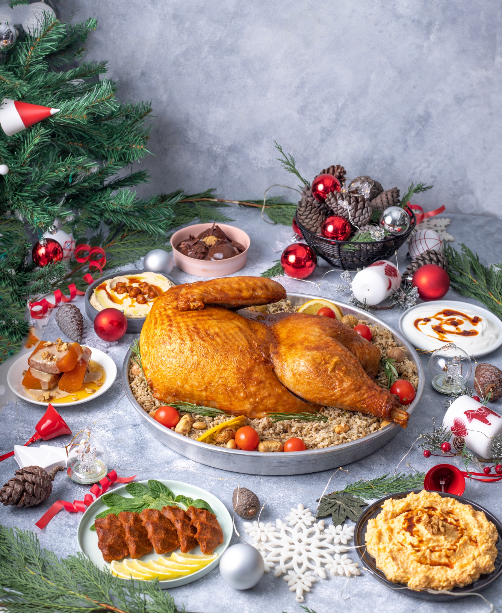 Large roasted turkey on a tray with chestnuts and tomatoes – overhead seasonal spread.