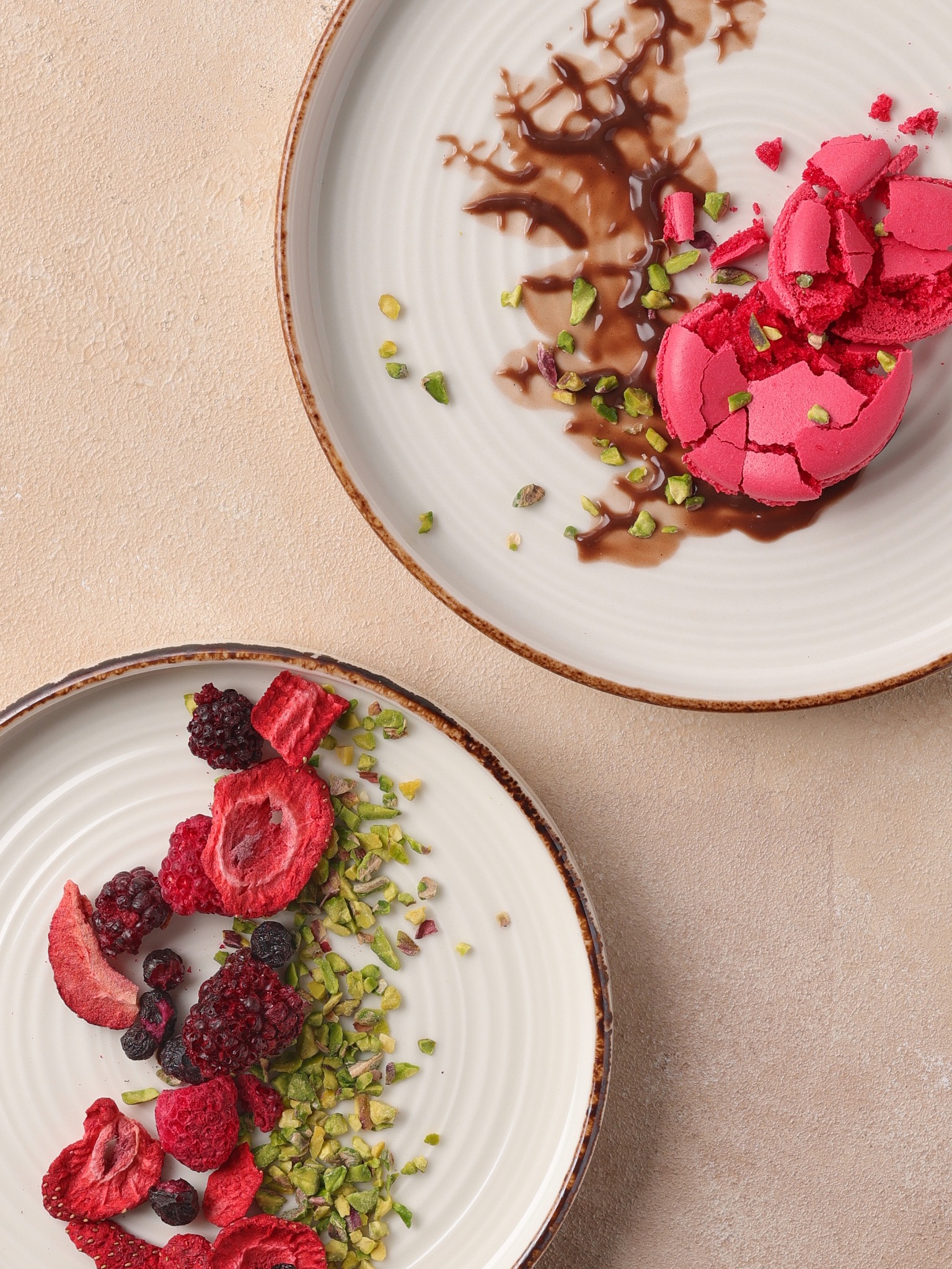 Cracked pink macaron with chocolate smear and pistachios – Atlanta dessert photography.