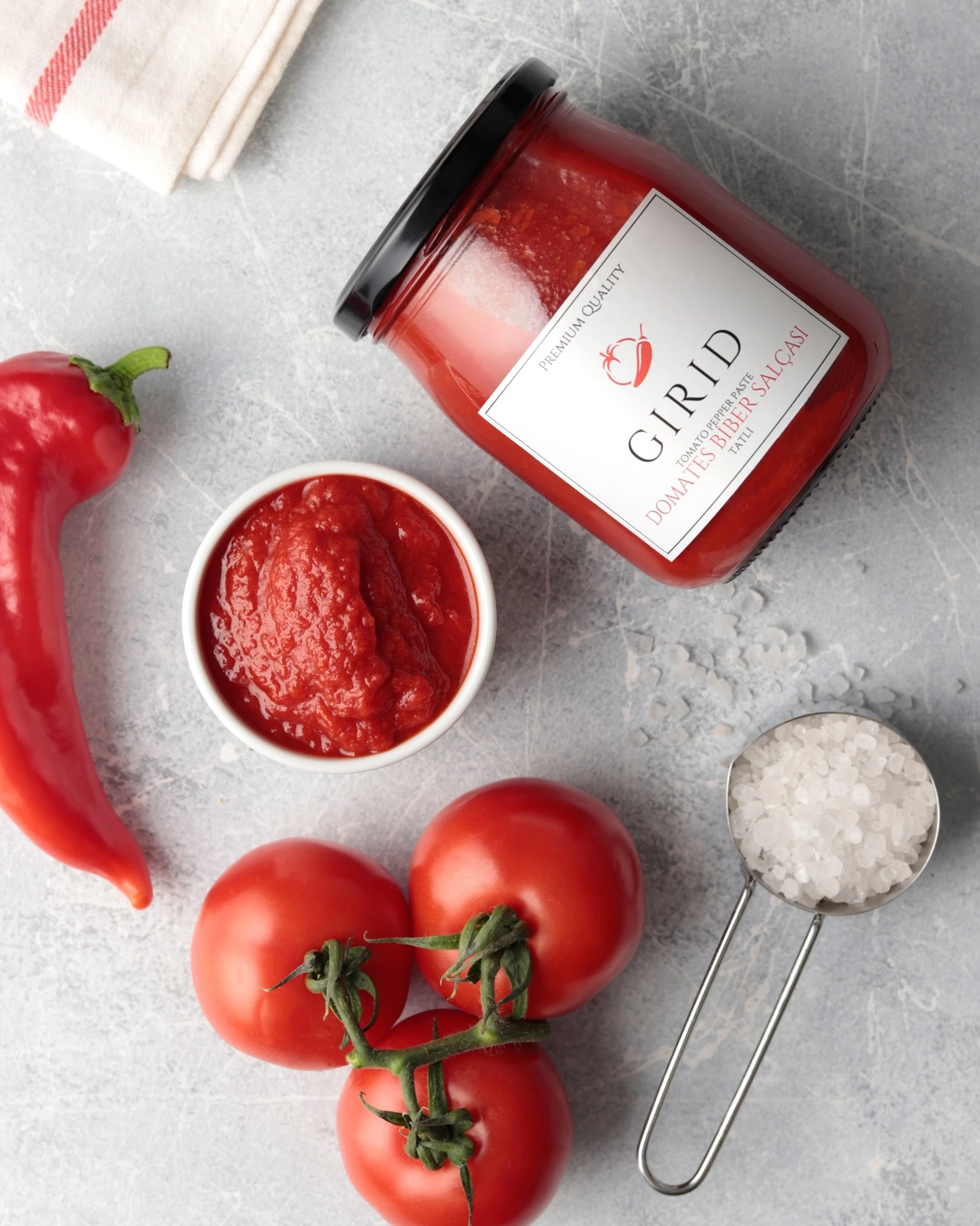 Extra virgin olive oil bottle product shot with pour glass and olive branch – Atlanta studio product photography.