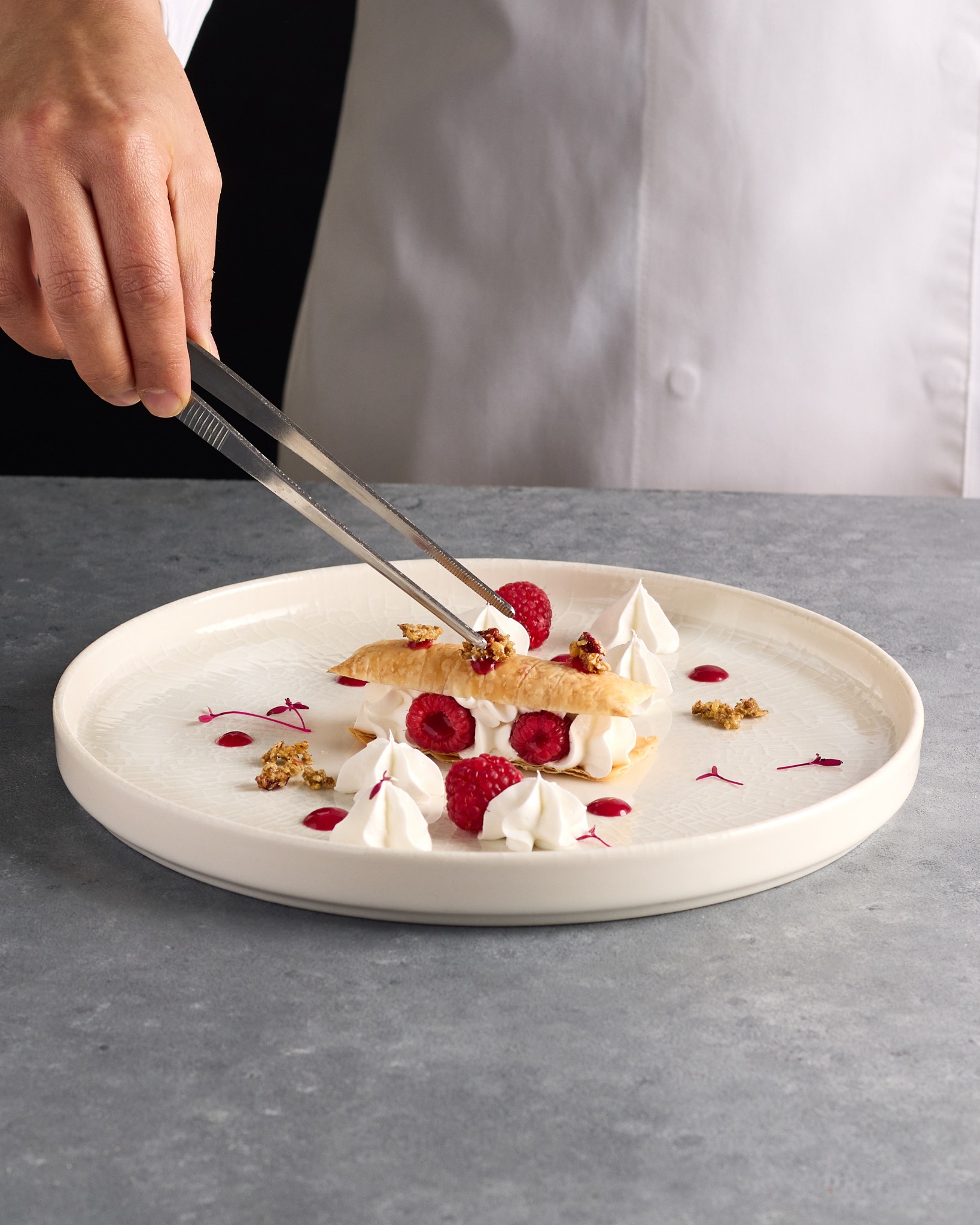 Yellow entremet with pistachios and tea – dessert product photography.